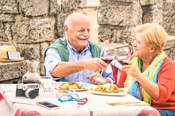 An older couple eating at a restaurant while on holiday